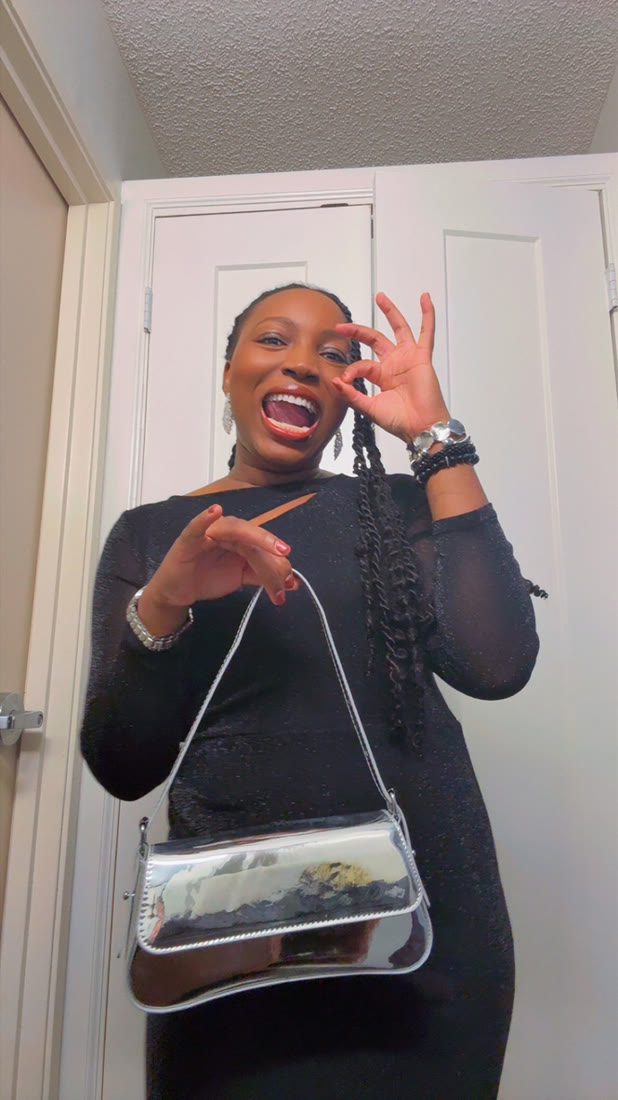 Shakeera in a black dress with a silver bag
